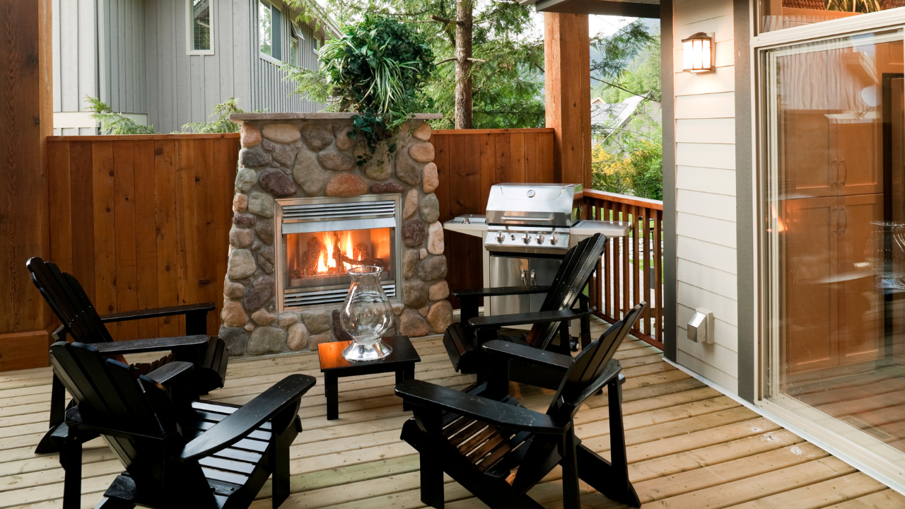Cozy fire in a fireplace on a deck surrounded by chairs